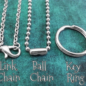May include: Three different types of chains: a link chain, a ball chain, and a key ring. All are silver in color.