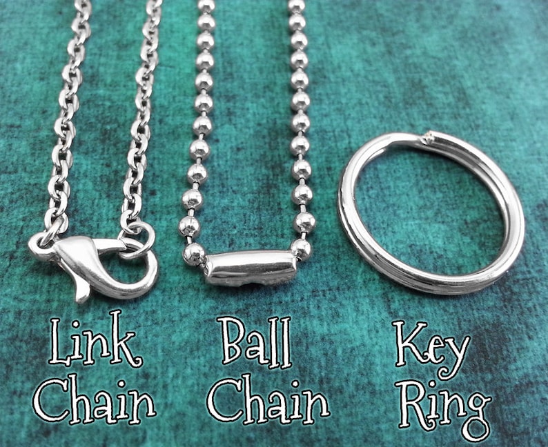May include: Three different types of chains: a link chain, a ball chain, and a key ring. All are silver in color.