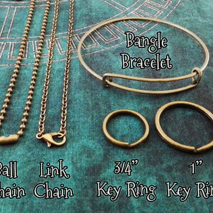 May include: Four different types of metal chains and two key rings. The chains are ball chain, link chain, bangle bracelet, 3/4 inch key ring, and 1 inch key ring.