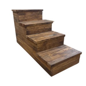 May include: A rustic wooden pet step with four steps. The steps are made of stained wood with visible grain, creating a natural, weathered appearance. The steps are designed to help pets reach higher surfaces.