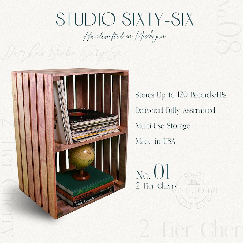 May include: A two-tier wooden record shelf made from reclaimed wood. The shelf is handcrafted in Michigan and can hold up to 120 records. It is delivered fully assembled and is made in the USA. The shelf is labeled "No. 01 2 Tier Cherry".