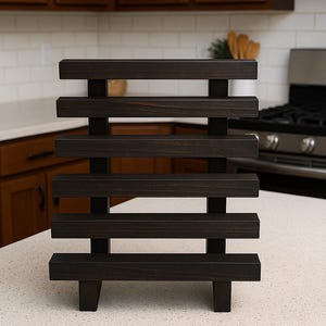 May include: Dark stained wooden shelf with horizontal slats and vertical supports. The shelf is labeled "Vintage Dark" in a white, sans-serif font. The shelf is on a white countertop in a kitchen.