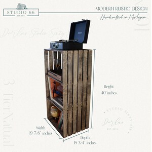 May include: A rustic wooden shelf unit with three tiers, made from reclaimed wood crates. The shelf is 40 inches tall, 19 7/8 inches wide, and 15 3/4 inches deep. It features a record player on the top shelf and a globe on the bottom shelf. The shelf is handcrafted in Michigan.