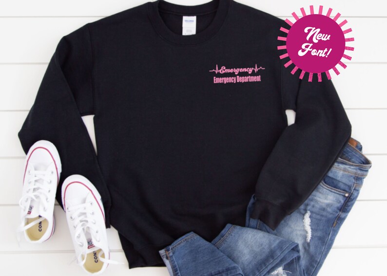 May include: Black sweatshirt with a pink graphic that reads "Emergency Emergency Department" with a heartbeat symbol.