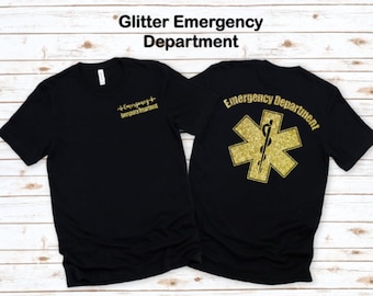 May include: Black t-shirt with gold glitter text and a gold glitter star of life on the back. The text on the front reads "Emergency Department". The text on the back reads "Emergency Department".