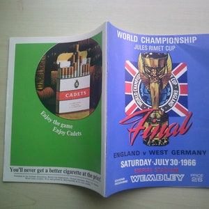 May include: A vintage magazine spread. One page displays a Cadets cigarette advertisement with the slogan "Enjoy the game, Enjoy Cadets." The other page is a blue World Championship Final program for England v West Germany, Saturday July 30 1966, at Wembley.