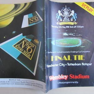 May include: An open magazine spread featuring a vintage advertisement for Player's No. 6 cigarettes and a football program. The cigarette ad shows a pack with a black, teal, and gold design. The program announces the Final Tie match between Manchester City and Tottenham Hotspur at Wembley Stadium.