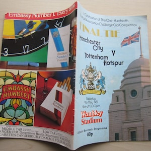 May include: A blue and white programme for the 100th Football Association Challenge Cup Competition Final Tie between Manchester City and Tottenham Hotspur. The game was played on Saturday, 9th May 1981 at Wembley Stadium. The programme costs 80p.