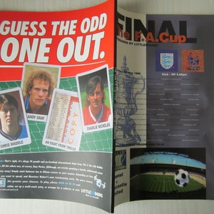 May include: A magazine spread with the headline "GUESS THE ODD ONE OUT." It features player portraits and text, including "THE F.A. CUP" and "Kick-Off 3.00pm." The Littlewoods logo is also visible.