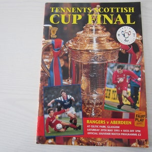 May include: A program cover for the Tennent's Scottish Cup Final between Rangers and Aberdeen. The cover features a photo of the trophy, a photo of a player from each team, and the text "Tennent's Scottish Cup Final", "Rangers v Aberdeen", "At Celtic Park, Glasgow", "Saturday 29th May 1993", "Kick-off 3pm", and "Official Souvenir Match Programme £2".