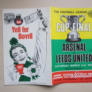 May include: A green and yellow program for the 1968 Football League Cup Final between Arsenal and Leeds United. The program features a drawing of a man holding a cup and the text "Yell for Bovril".