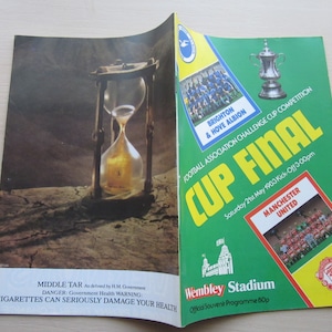 May include: A green and yellow program for the Football Association Challenge Cup Final between Brighton & Hove Albion and Manchester United. The game was played on Saturday, May 21st, 1903 at Wembley Stadium. The program features a photo of the teams and a warning about the dangers of smoking.