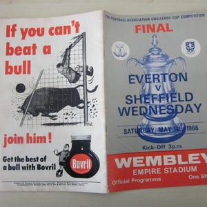 May include: Vintage football program from the 1966 Football Association Challenge Cup Final, featuring Everton versus Sheffield Wednesday. The cover is gray and red with a trophy illustration. The left page has a cartoon with the text "If you can't beat a bull, join him!"