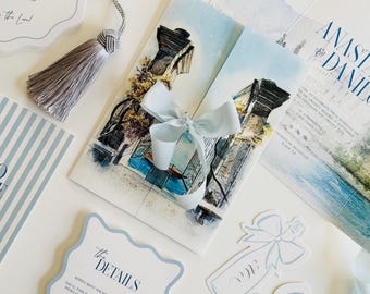 May include: Elegant wedding stationery set featuring a light blue and white color scheme. Includes invitations, menu cards, and decorative elements with architectural illustrations and the text "Anastasia & Daniel".