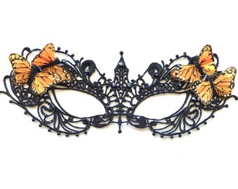 May include: Black lace masquerade mask with two orange butterfly embellishments.