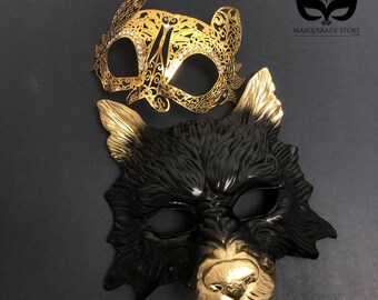 Par de máscaras de animales negras y doradas: gato y lobo