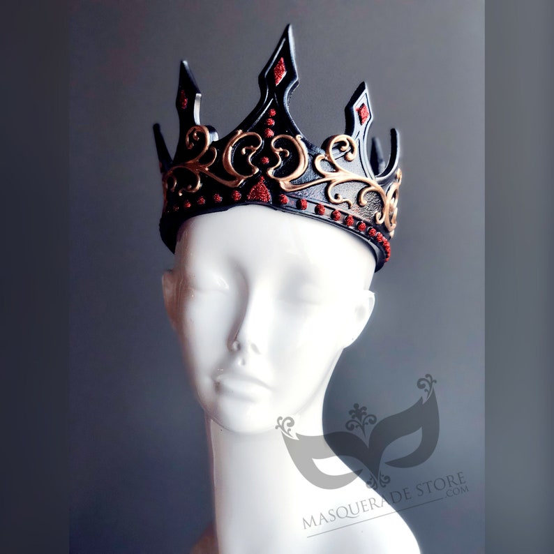 Black kind or queen crown for cosplay Halloween costumes. It’s made of rubber base and hand painted in gold and red glitter trim. There is Velcro in the back for adjusting. The base is black and sits on the head of the mannequin.