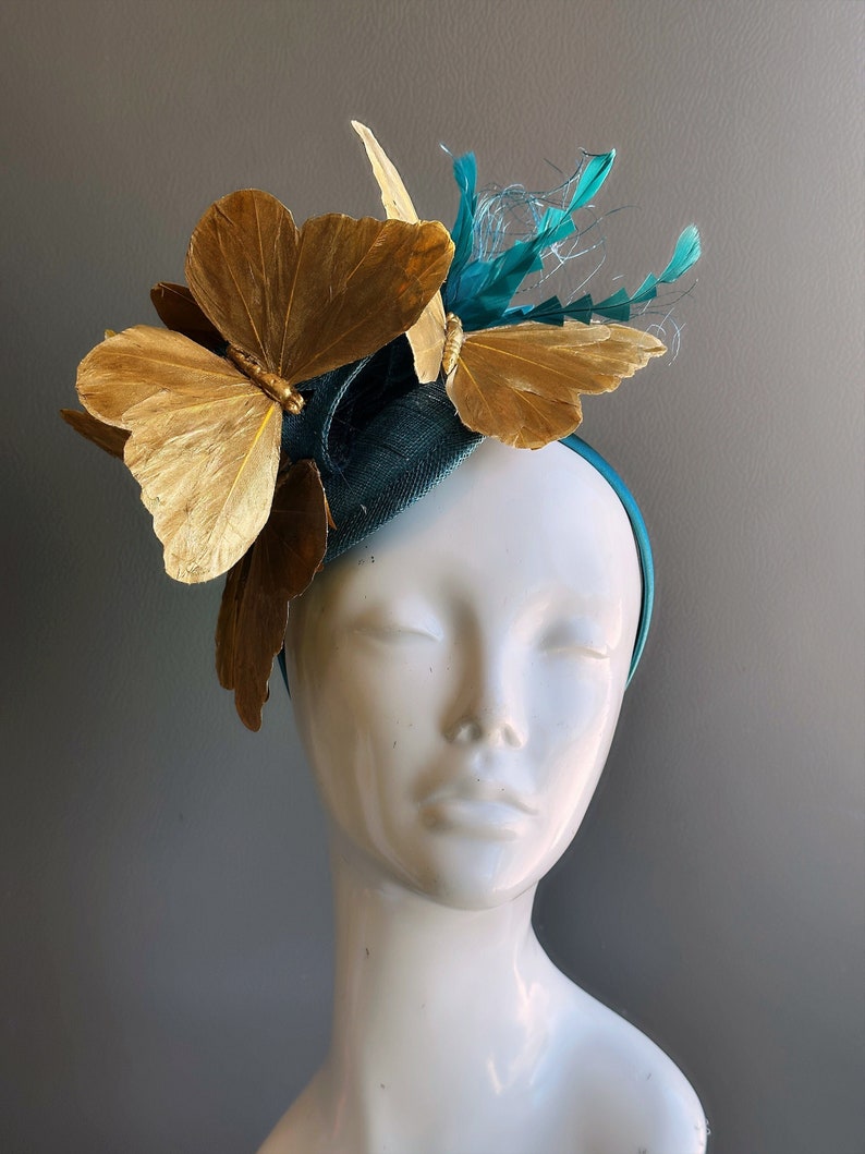 Butterfly tea party fascinator hat in teal and gold.