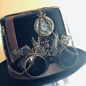 May include: Black plague doctor hat with brown leather accents, embellished with a pocket watch, goggles, and decorative metalwork. The hat has the text "Plague doctor hat - embellished".