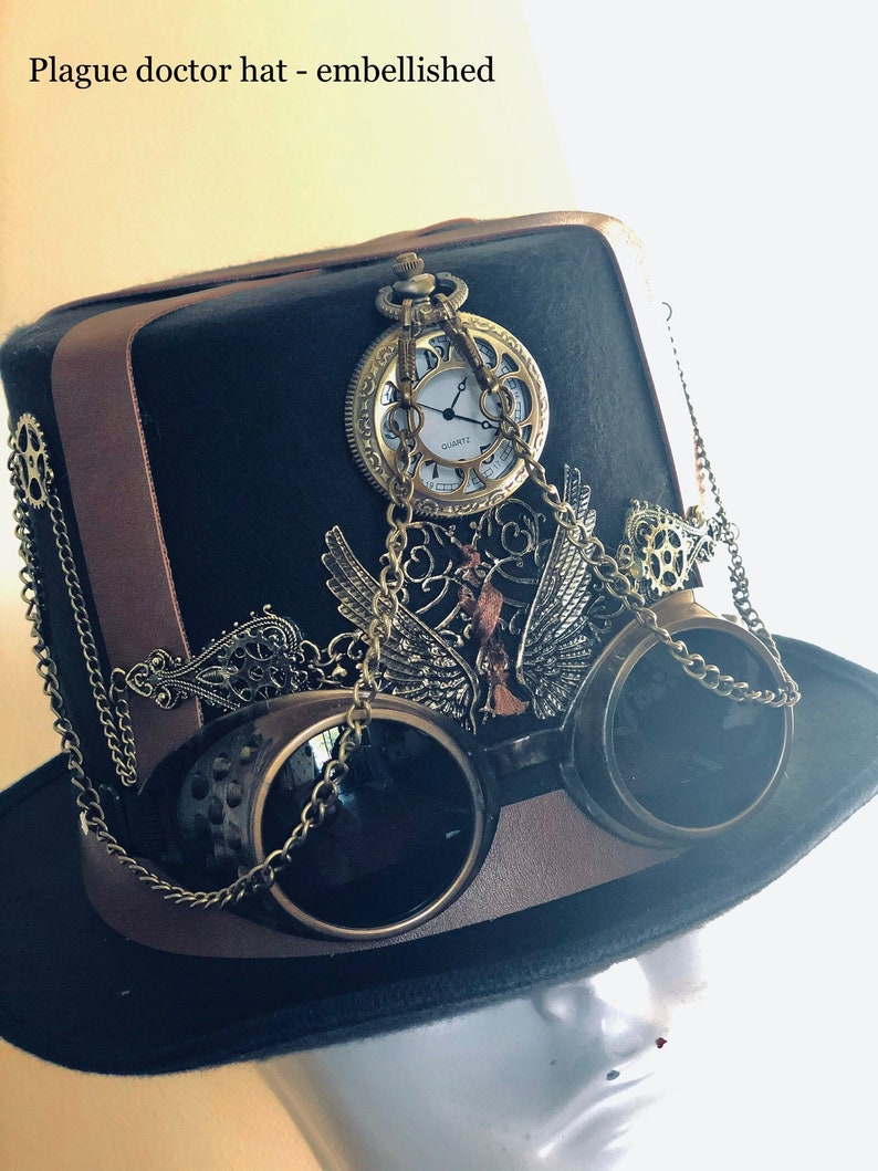 May include: Black plague doctor hat with brown leather accents, embellished with a pocket watch, goggles, and decorative metalwork. The hat has the text "Plague doctor hat - embellished".