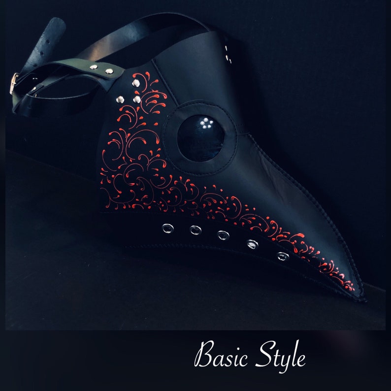 May include: Black leather plague doctor mask with a red floral design and a clear eye piece.  Basic Style.