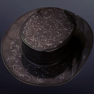Puede incluir: Un sombrero vaquero de cuero negro con un dise&ntilde;o floral plateado.