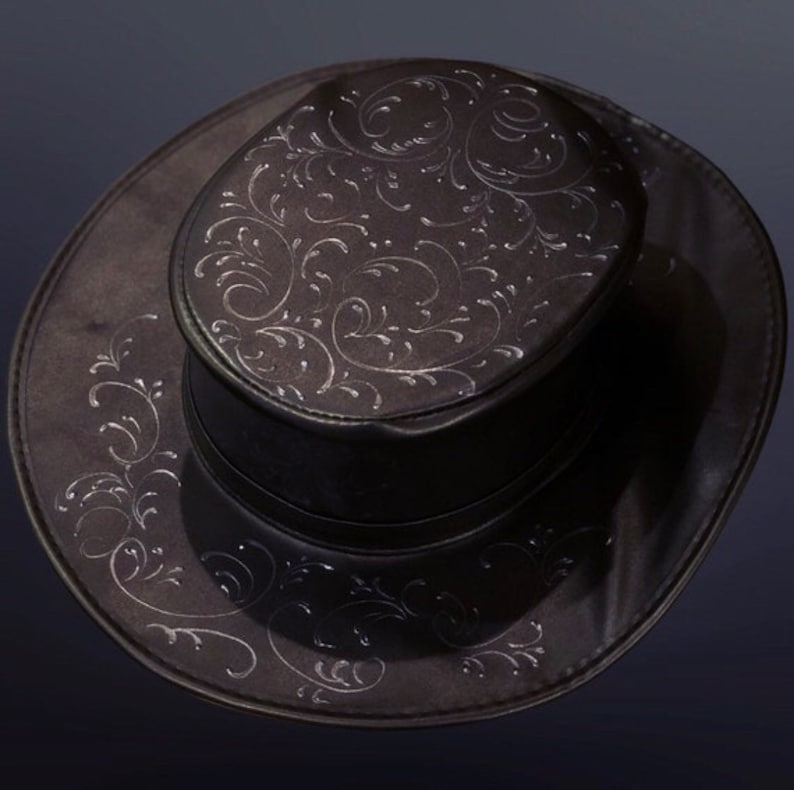 May include: A black top hat with a wide brim and a decorative floral pattern.