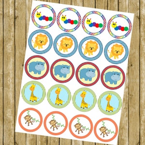 May include: A sheet of 24 round cupcake toppers featuring various jungle animal designs. The toppers include a colourful caterpillar, a lion, a hippopotamus, a giraffe, and a monkey.