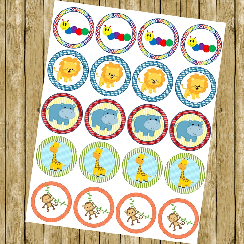 May include: A sheet of 24 round cupcake toppers featuring various jungle animal designs. The toppers include a colourful caterpillar, a lion, a hippopotamus, a giraffe, and a monkey.