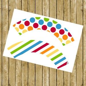 Op de afbeelding: Printbare cupcake-verpakkingen met een kleurrijk stippen- en strepenpatroon. De verpakkingen hebben de vorm van een halve cirkel.