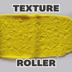 May include: A blue textured roller with a repeating pattern of autumn leaves, pumpkins, and turkeys, shown pressing into a flat sheet of bright yellow clay. The text "TEXTURE ROLLER" is displayed in bold white letters at the top and bottom.