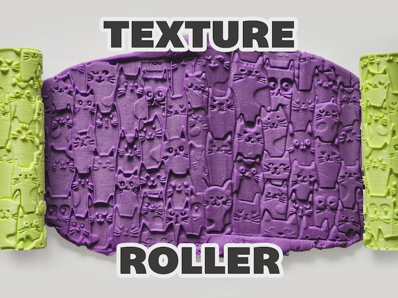 May include: A light green cylindrical texture roller featuring a repeating cat face pattern, shown alongside a purple slab of clay impressed with the same cat design. The text "TEXTURE ROLLER" is displayed in bold white letters above and below the clay.