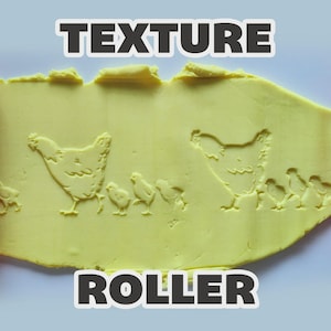 May include: A red cylindrical texture roller positioned on the left and right sides of a yellow clay slab. The clay features an embossed pattern of a hen followed by three small chicks. The text "TEXTURE ROLLER" is printed in white at the top and bottom.
