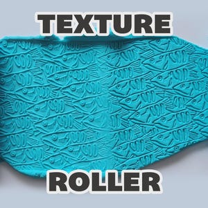 May include: A light blue texture roller featuring a repeating fish pattern, shown pressing into a flat piece of matching blue clay. The text "TEXTURE ROLLER" is displayed in bold white letters with a black outline at the top and bottom.