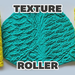 May include: Two bright yellow cylindrical texture rollers flank a central teal-colored slab of material. The rollers and the slab feature a repeating embossed pattern of small fish swimming through aquatic vegetation. The text TEXTURE ROLLER is visible.