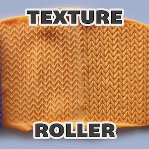 May include: Two purple cylindrical texture rollers with a repeating chevron pattern positioned on either side of a rectangular piece of orange clay that has been imprinted with the same chevron design. The text TEXTURE ROLLER is visible.