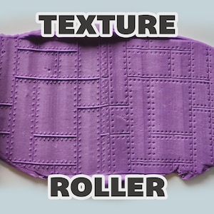 May include: Two light blue cylindrical texture rollers positioned on the left and right sides of a purple clay slab. The clay features an embossed pattern of rectangular metal plates with raised rivets. The text TEXTURE ROLLER is visible.