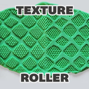 May include: Two cylindrical magenta texture rollers positioned on the left and right sides of a central green clay slab. The clay displays a repeating diamond-shaped grid pattern impressed by the rollers. The text "TEXTURE ROLLER" is visible.