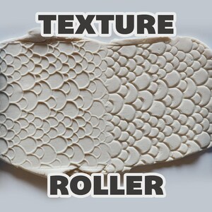 May include: Two bright blue cylindrical texture rollers with a repeating fish scale pattern, positioned on either side of a flattened piece of off-white clay that displays the embossed scale texture. The text TEXTURE ROLLER is visible.