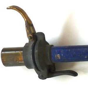 May include: A blue and brass tire pump with a wooden handle. The pump has a blue rubber hose and a brass nozzle.