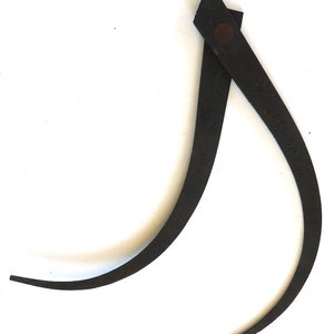 May include: A black metal compass with a rounded shape and a small rivet on the top. The compass is marked "MADE IN U.S.A."