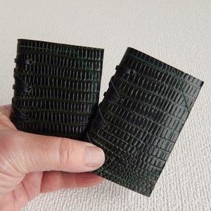 2 Green Dragon (not real dragon) leather covered needle case with four white felt pages for your pins, needles etc. in a variety of different leathers and colours.  Decorated with incised lines to resemble a bound book with a thong stitched spine.
