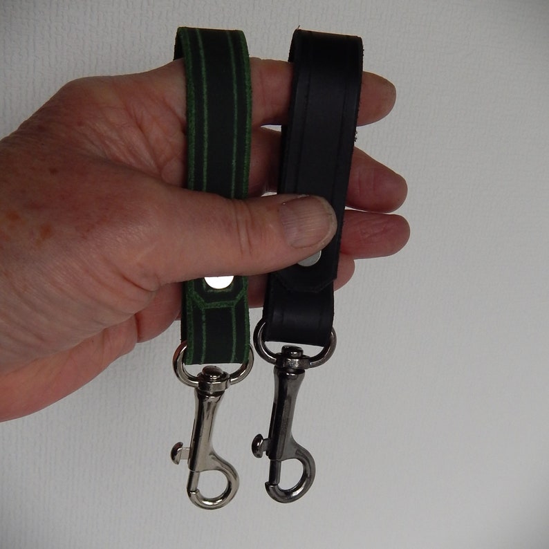 Simple, strong and useful leather loops with a metal spring clip firmly attached.  Use on a belt or strap to hold small items - such as keys, a hand towel, etc - or as a keyring in its own right.  Two shown in a hand