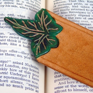 Detail of the green, cut out leaf leather bookmark on an open book