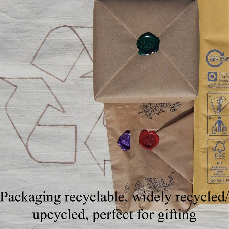 3 items packed for dispatch in brown kraft paper with wax seals.  The back of a postal envelope showing eco credentials, all on a recycle logo stating:  Packaging recycleable, widely recycled/ upcycled, perfect for gifting