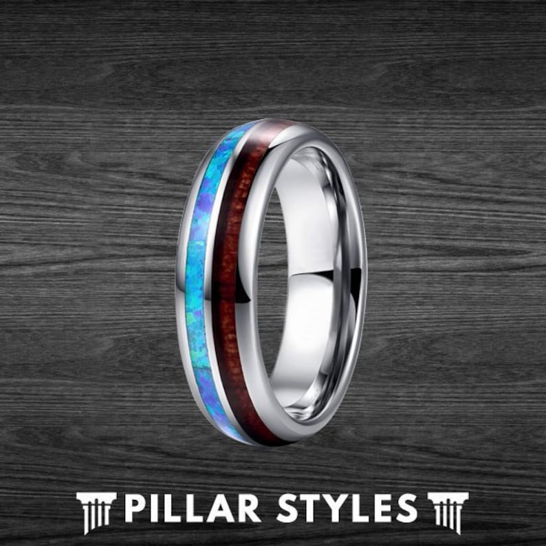 May include: A silver tungsten carbide ring with a blue and brown inlay. The ring has a polished finish and a beveled edge.