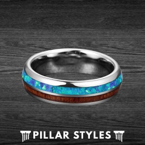 May include: A silver ring with a blue and brown inlay. The ring has a polished finish and a smooth surface.