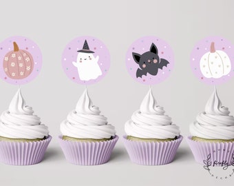 May include: Four purple and white cupcake toppers with Halloween themes. The toppers feature a ghost, a bat, and two pumpkins. The toppers are on top of cupcakes with white frosting.