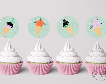 May include: Four cupcakes with pink liners topped with white frosting and decorated with round, green and white Halloween-themed ice cream cone toppers. The toppers feature a ghost, a pumpkin, a spider, and a bat.