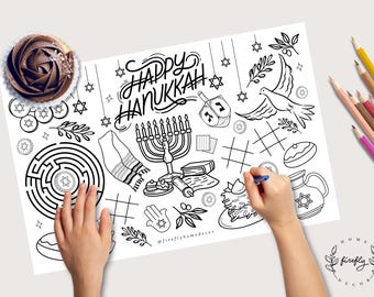 May include: Black and white Hanukkah-themed coloring page with the words "Happy Hanukkah". Includes illustrations of a menorah, dreidel, dove, and other holiday symbols. A chocolate cupcake with frosting is in the upper left corner.